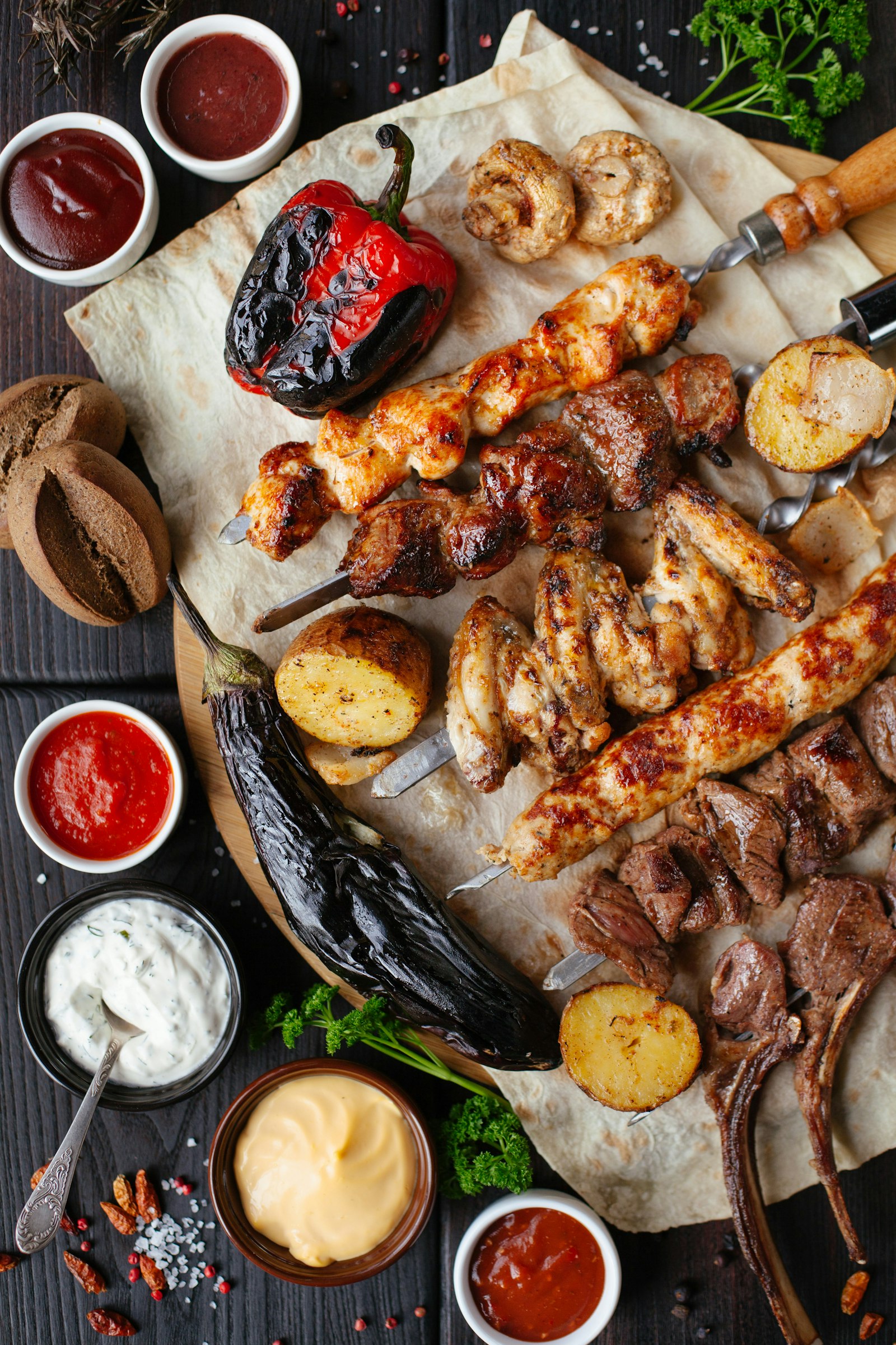 Skewers over open coals, flames rising